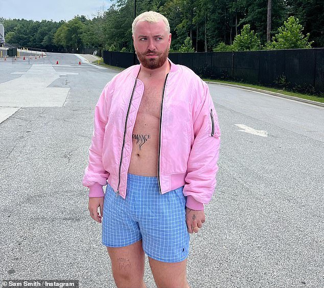 Sam Smith Embraces Their Inner Ken Doll As Star Pictured Wearing PINK Bomber Jacket & Blue Check Shorts