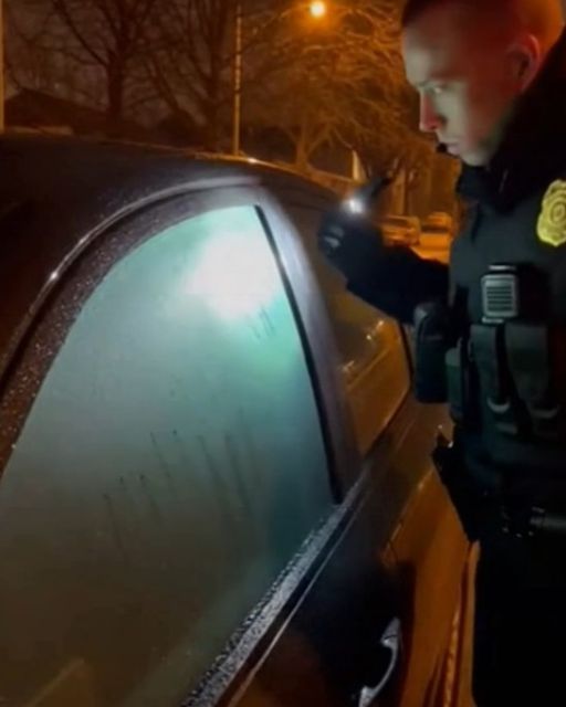 Police Officer Checks A Car With Fogged Windows—the Engine Is Off